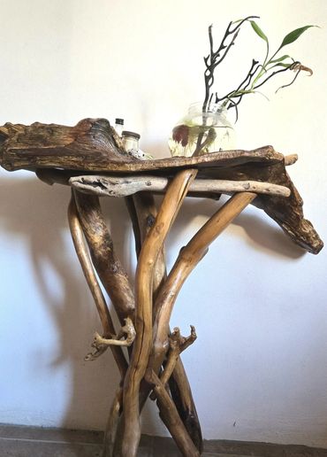 Rustic wooden table made from intertwined natural branches.