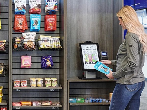 Woman shopping snacks in a modern micro-market store.