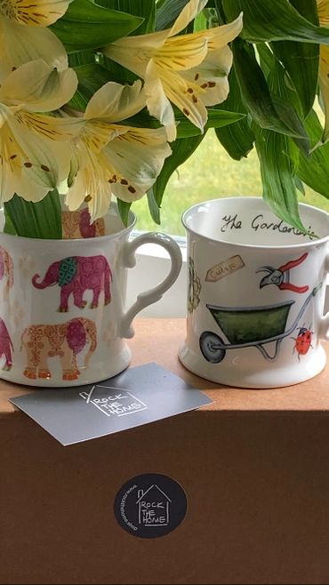 Elephant mug and gardening mug on cardboard box