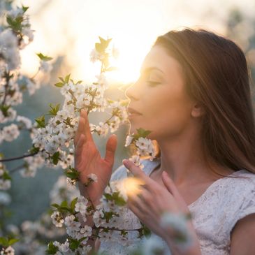 Woman smelling cotton flowers