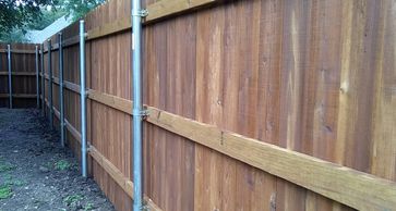 Standard privacy fence with steel posts, three treated rails and cedar fence pickets