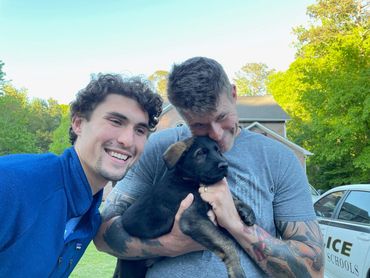 John Surowiec, trainer with son Luke and Conan new German Shepherd pup.