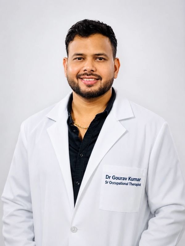 Smiling man in a white lab coat with name tag Dr. Gourav Kumar, Sr Occupational Therapist.