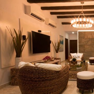 Cozy living room with woven furniture and warm lighting.