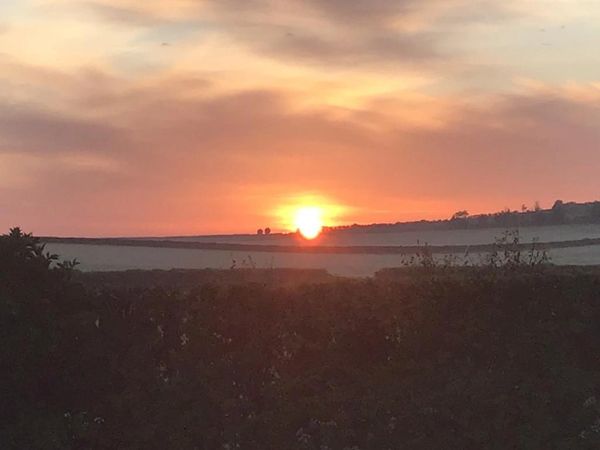 View of Dorset countryside sunset from Rustic Stay shepherds huts glamping holidays