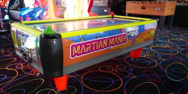 An arcade air hockey table named "Martian Mania".
