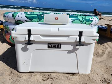 Fun beach day setup with cabanas, giant flamingo float, and beach games in West Palm Beach.