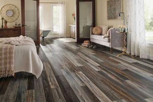 Bedroom with vintage multi-color wood-look floor.