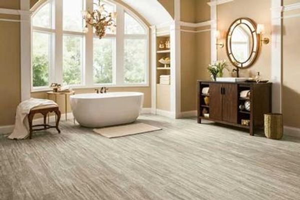 Bathroom with travertine-look vinyl floor and a tub.