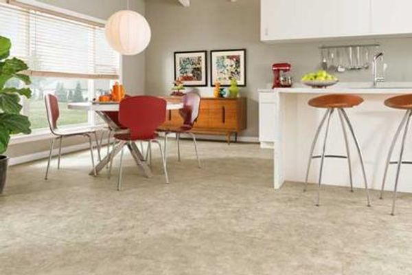 Dining and kitchen area with light vinyl floor tile.