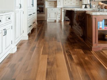 Kitchen with glossy hardwood floor and white cabinets.
