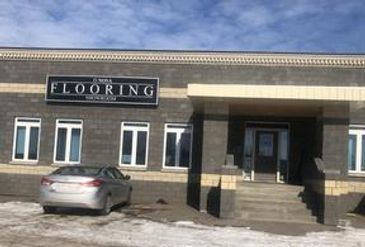 Exterior of Flooring business building on a sunny day.