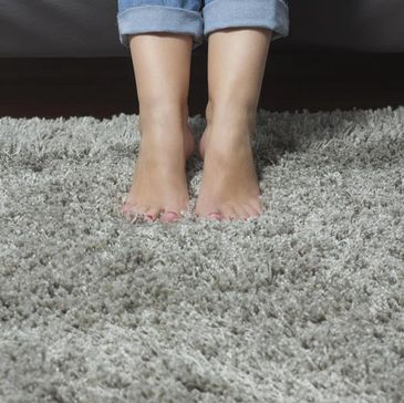Bare feet on a plush shag rug.