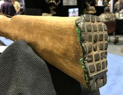 The butt is rubber backed with cloth and stapled and nailed onto the wood.