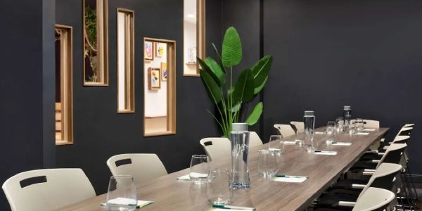 Modern conference room luxury paint with a long wooden table and white chairs.