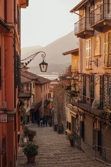 Cobblestone street in a peaceful town at sunset.
