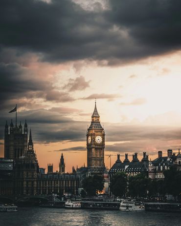Big Ben under a dramatic cloudy sky at sunset.