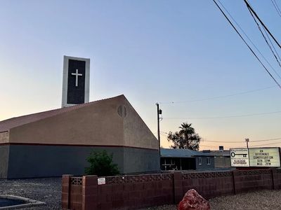 Church building with cross and sign