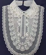 A 3D Montage of embroidered layers build up Vintage look Bib.
If