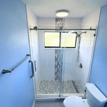 Remodeled bathroom with blue walls and beautiful new shower