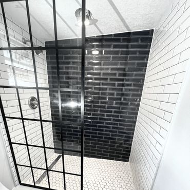 Renovated shower with black and white tile work