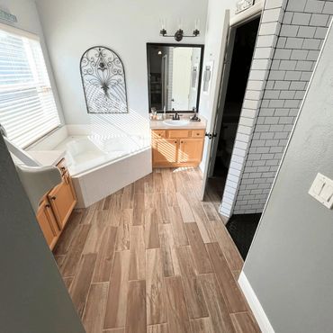 Remodeled bathroom with new shower, tub, flooring and vanity