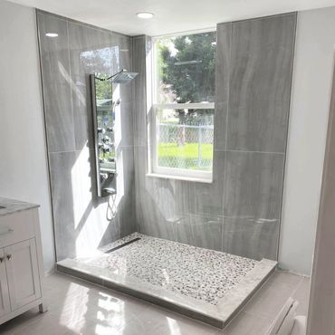 Newly renovated shower with tile work and fixtures