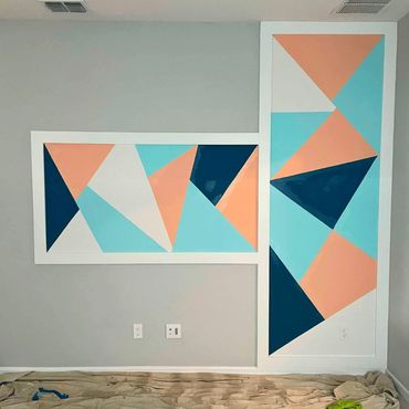 Gray wall with a design of shapes painted on it