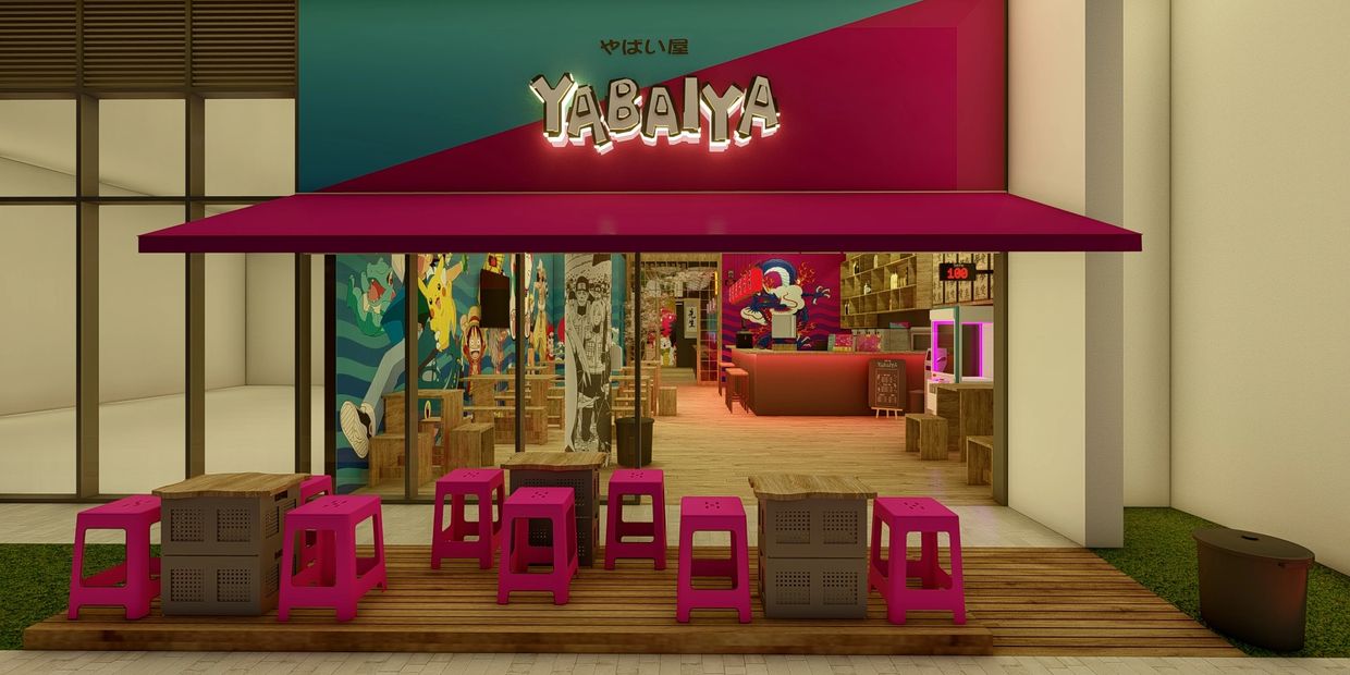 Front view of YABAIYA cafe with bright pink stools and colorful anime-themed murals.