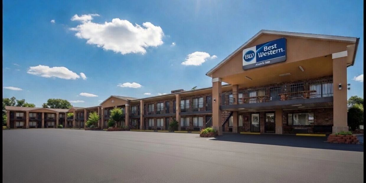Exterior view of a Best Western hotel under a clear blue sky.
