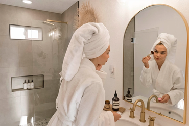 Airbnb photography of a guest getting ready in a modern vacation rental bathroom in Landers, CA