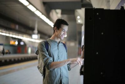 Person withdrawing cash using reliable outdoor atm services outside.