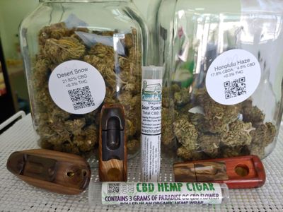 2 jars of Hemp flower loose bud with hand carved wooden pipes and pre-rolled joints.