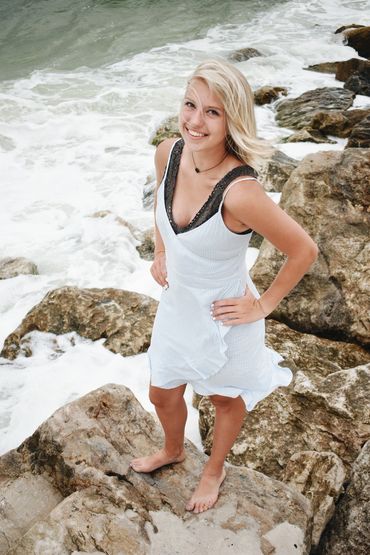 Julia stands on beach rocks