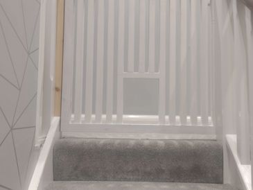 Custom built baby gate with cat opening installed in a domestic home in Port Erin, Isle of Man.