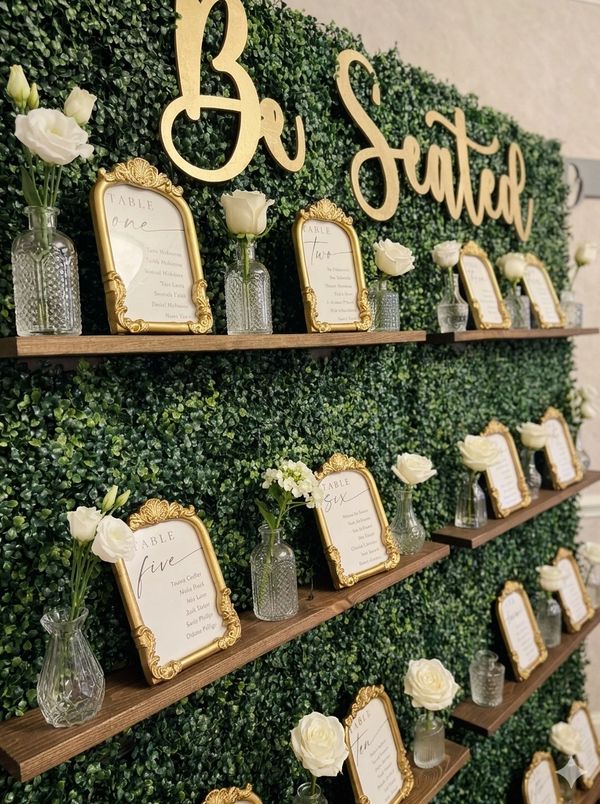 Seating chart picture frame with white flowers on bud vases