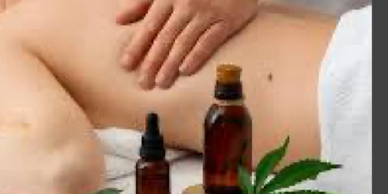 Massage therapist performing massage therapy with CBD oils.