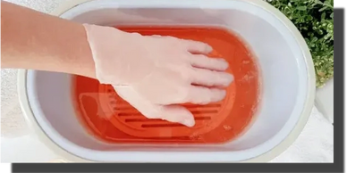 Massage therapist performing Paraffin Wax treatment.