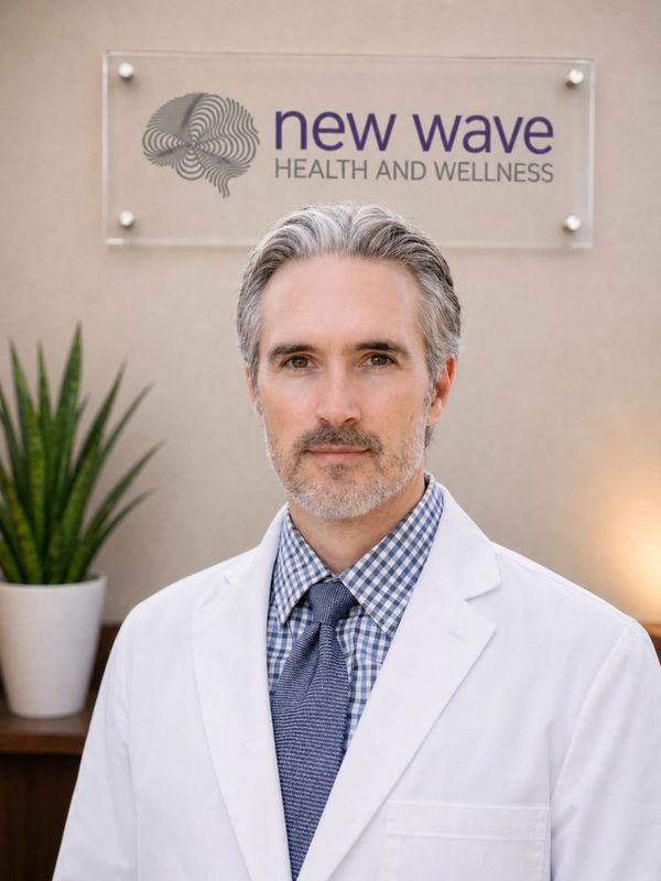 Professional man in a white coat standing in a wellness clinic.