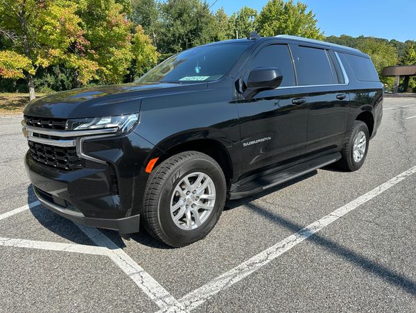 Side profile of a black Chevrolet Suburban.
