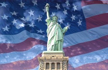Statue of Liberty with American flag overlay in the background.