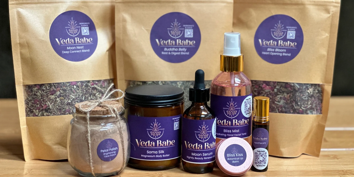 Veda Babe natural wellness and beauty products arranged on a table.