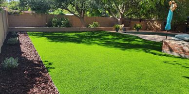 Large turf yard with stone patio