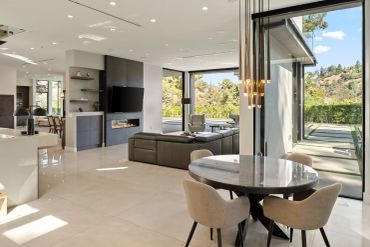 Modern open living space with large windows and sleek furniture.