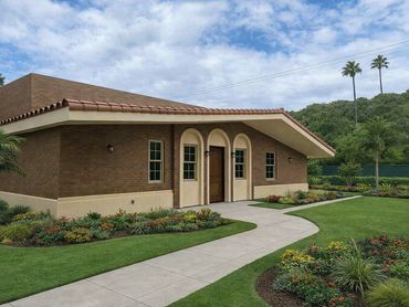 Modern brick house with a tiled roof and landscaped garden.