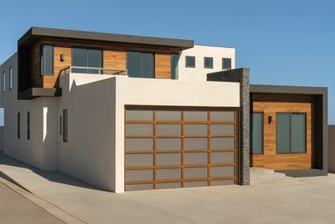 Modern two-story house with wood and stone accents under clear blue sky.