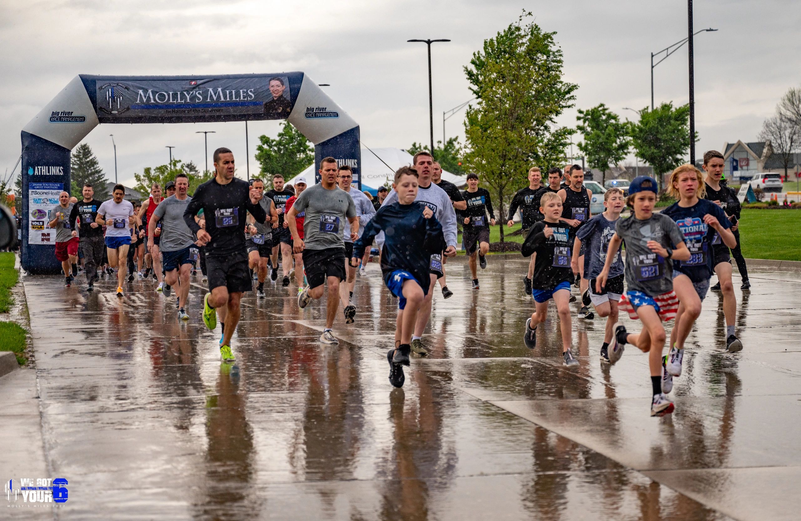 Adults and youth running at the start line of Molly's Miles