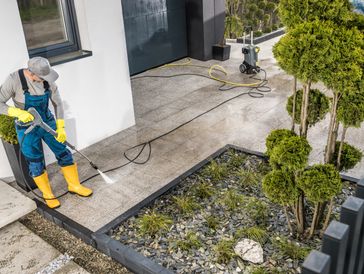 man pressure washing a house near Galveston Texas