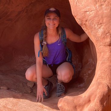 Sexy woman squatting in cave