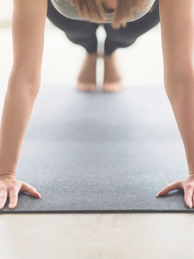 Person doing Pilates plank on a mat